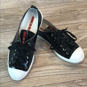 Prada Black patent leather sneakers.